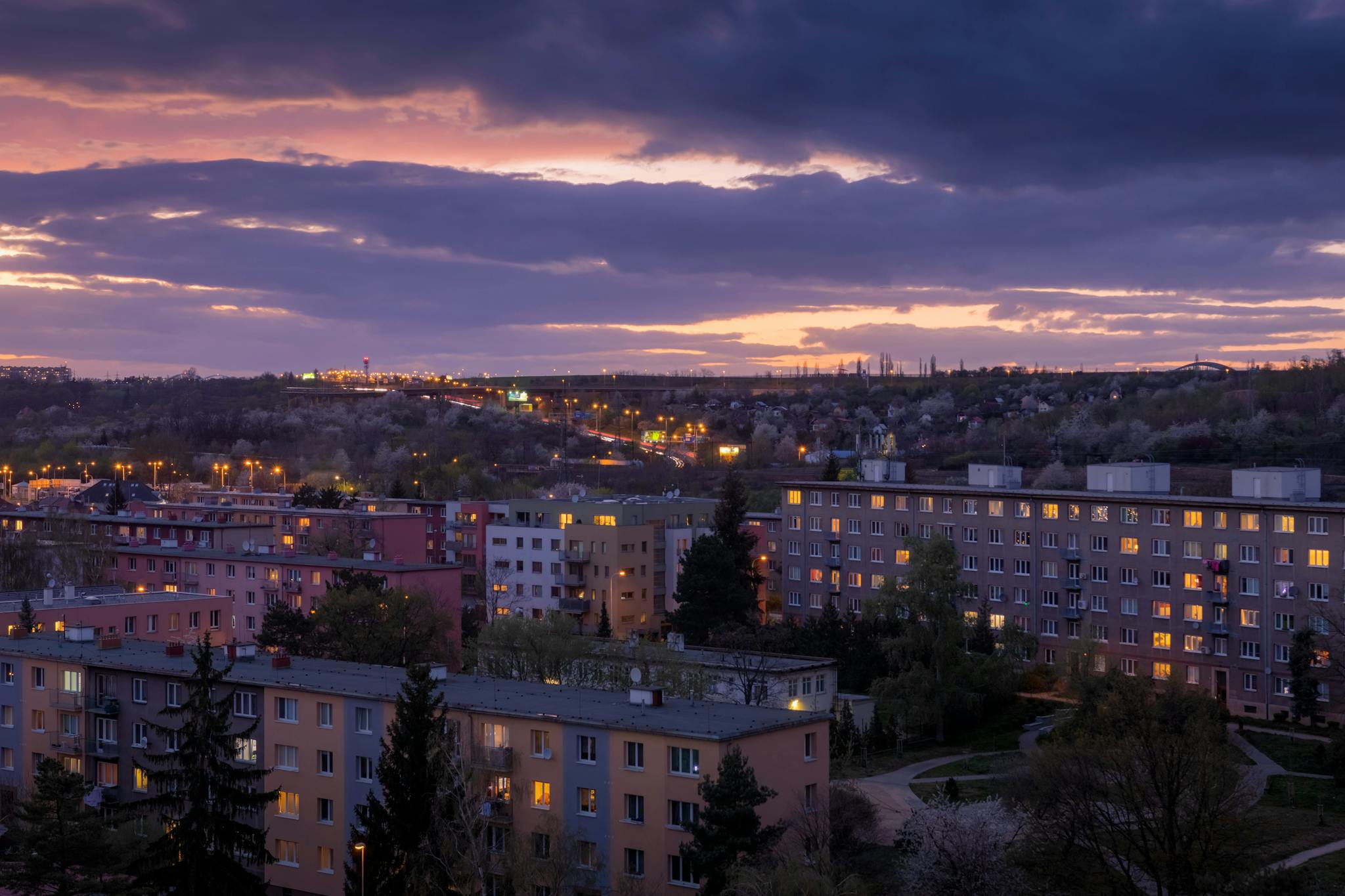 A scenic twilight view over residential buildings in Prague, Czechia, highlighting urban architecture.